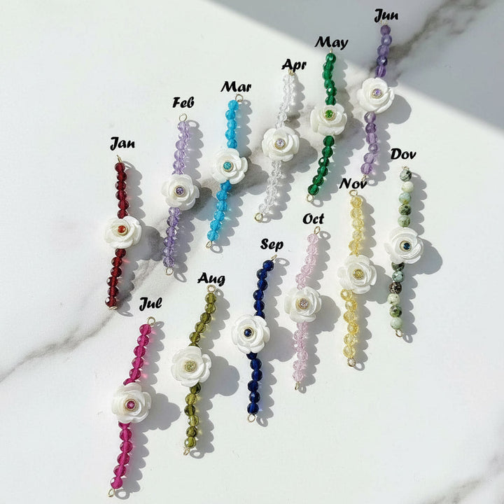 Birthstone flower bracelets in 12 colors for each month, featuring white carved flower charms with gemstone beads.