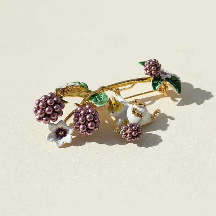 Decorative brooch with berries and flowers on a beige background