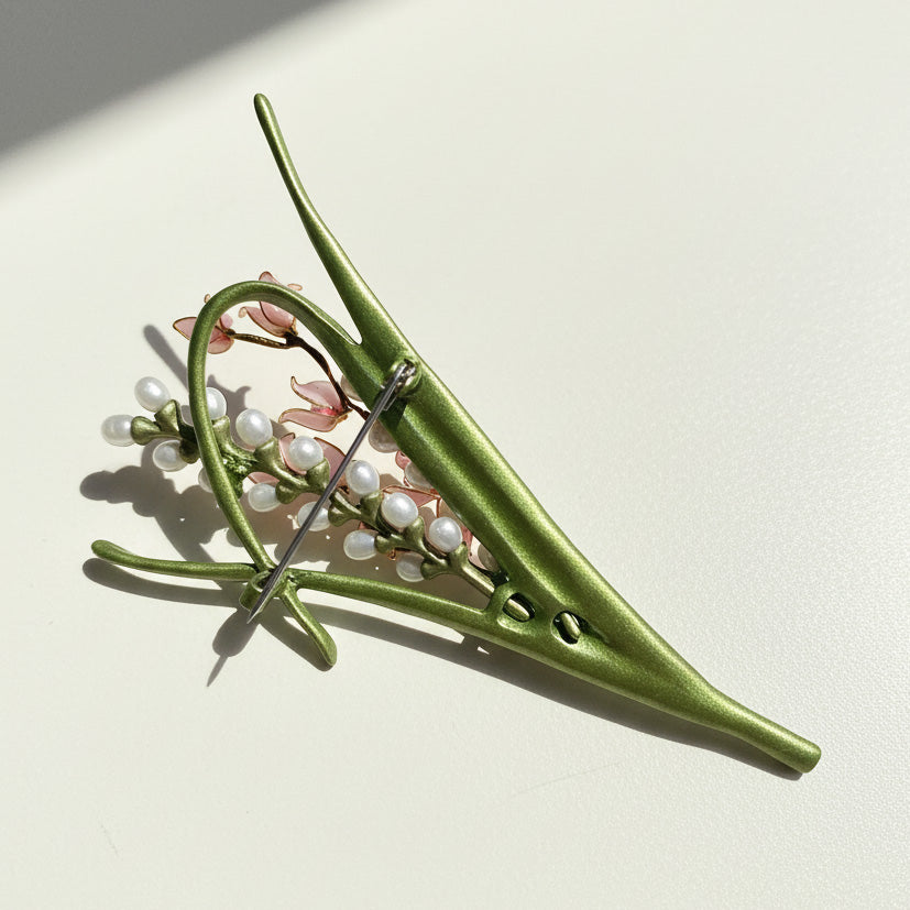Back view of crafted floral brooch with nickel-color plated pin