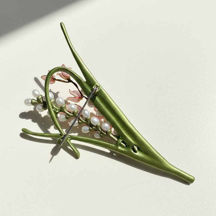 Back view of crafted floral brooch with nickel-color plated pin