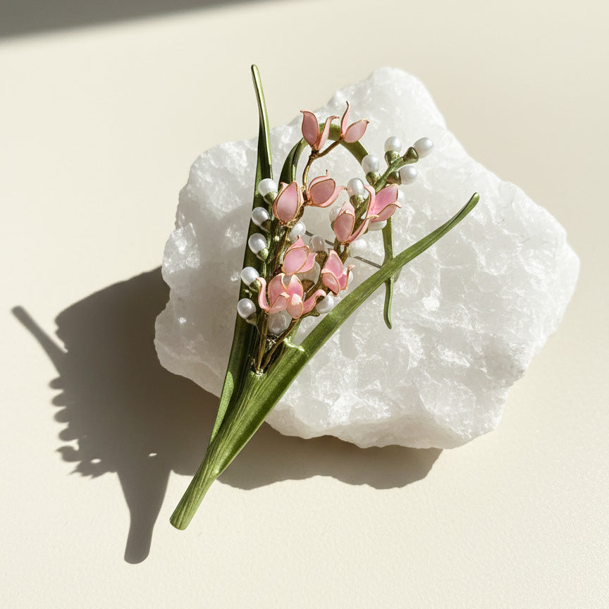 Lily of the valley flower brooch with hand-painted resin petals and enamel leaves on white rock