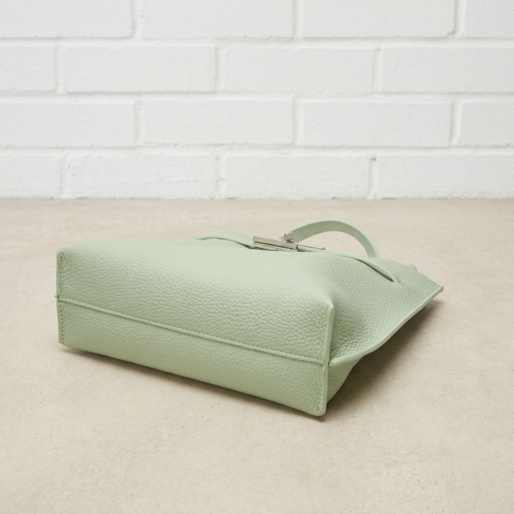 Bottom view of the Sage Green Soft Grain Mini Shoulder Bag highlighting the pebbled leather texture, stitching, and structured base.