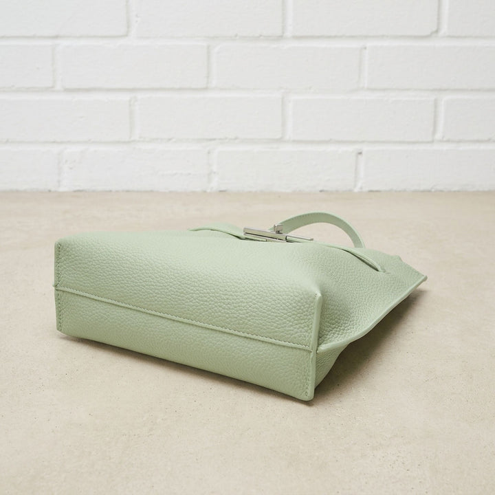 Bottom view of the Sage Green Soft Grain Mini Shoulder Bag highlighting the pebbled leather texture, stitching, and structured base.