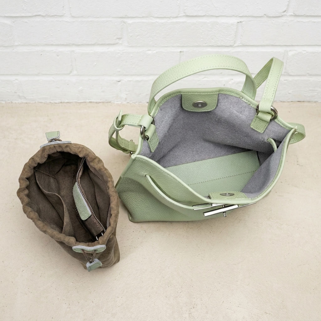 Close-up of the Sage Green Soft Grain Mini Shoulder Bag showing its open interior, lining, and leather construction