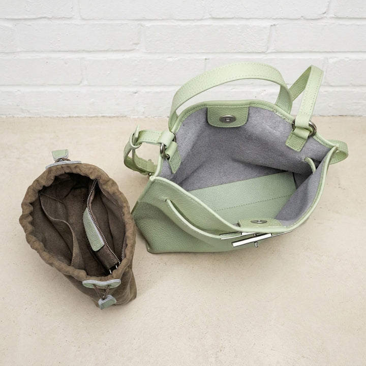 Close-up of the Sage Green Soft Grain Mini Shoulder Bag showing its open interior, lining, and leather construction
