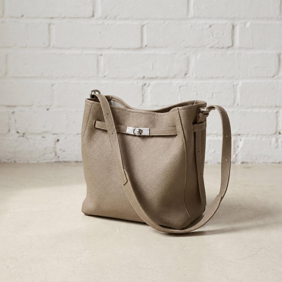 Taupe Belted Bucket Bag with a softly structured silhouette, pebbled leather finish, silver-tone hardware, and adjustable strap.