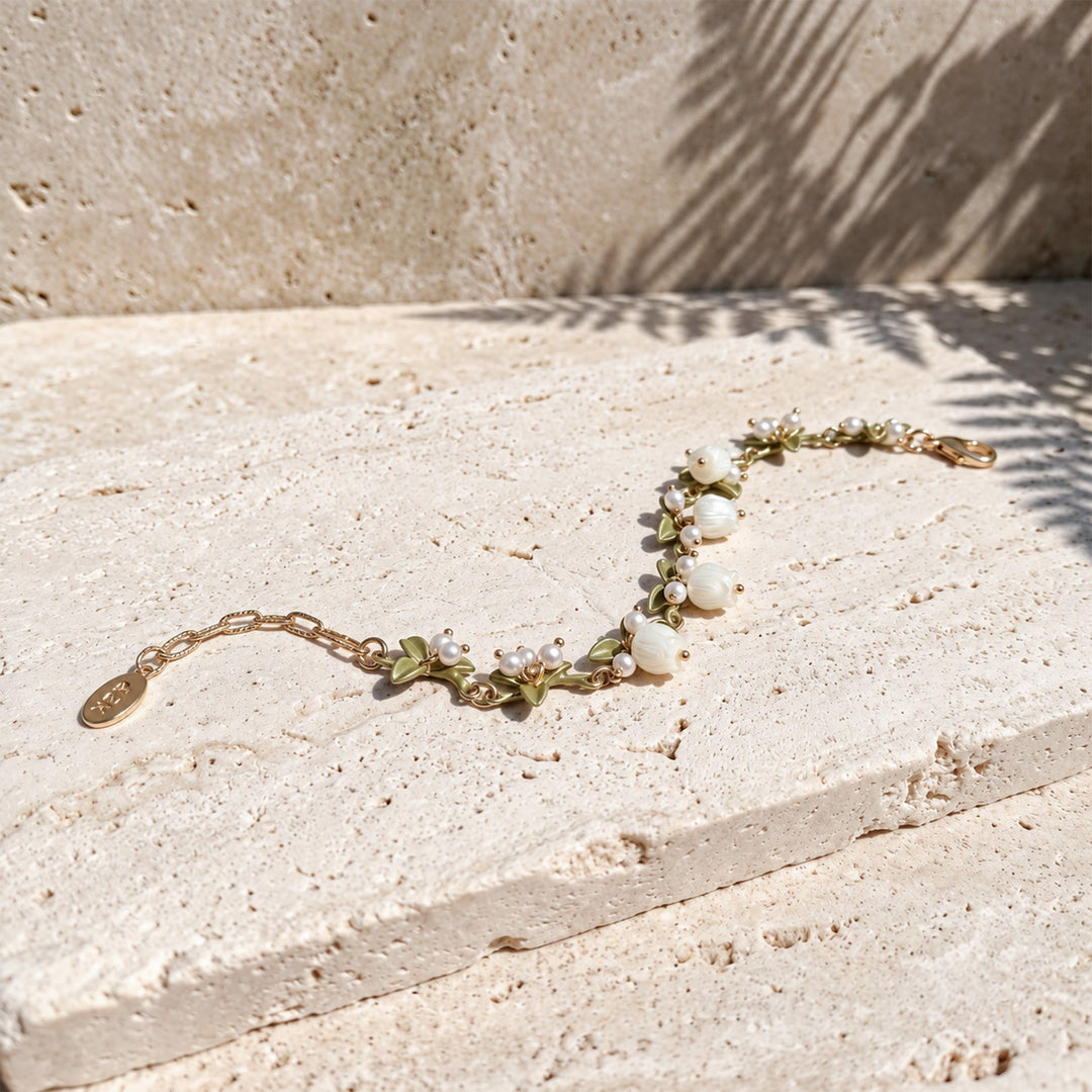 mother-of-pearl Lily of the Valley flowers, freshwater pearls and enamel leaves on the bracelet.