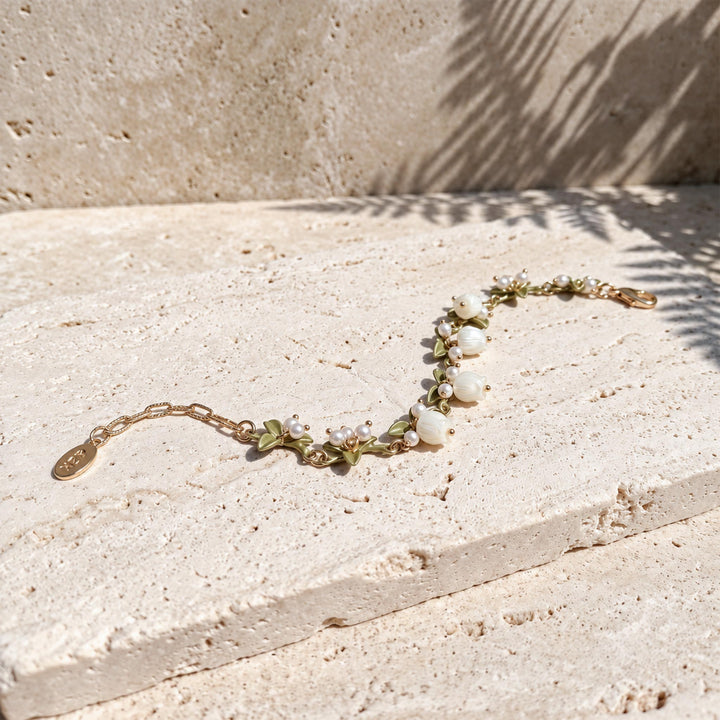 mother-of-pearl Lily of the Valley flowers, freshwater pearls and enamel leaves on the bracelet.