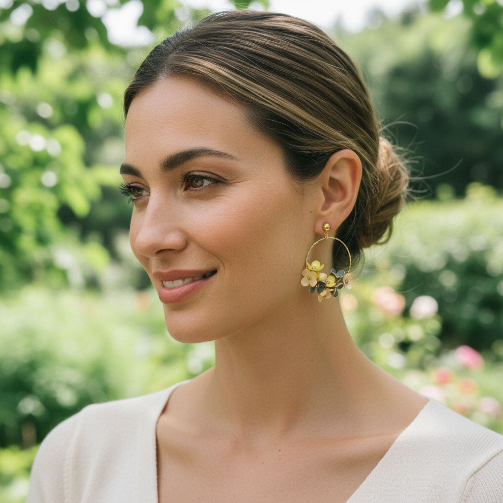 Woman wearing floral earrings in a garden setting