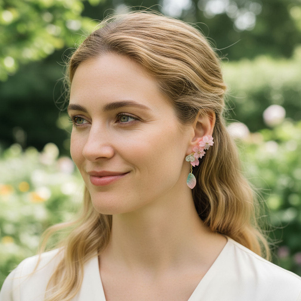 Woman wearing floral earrings in a garden setting