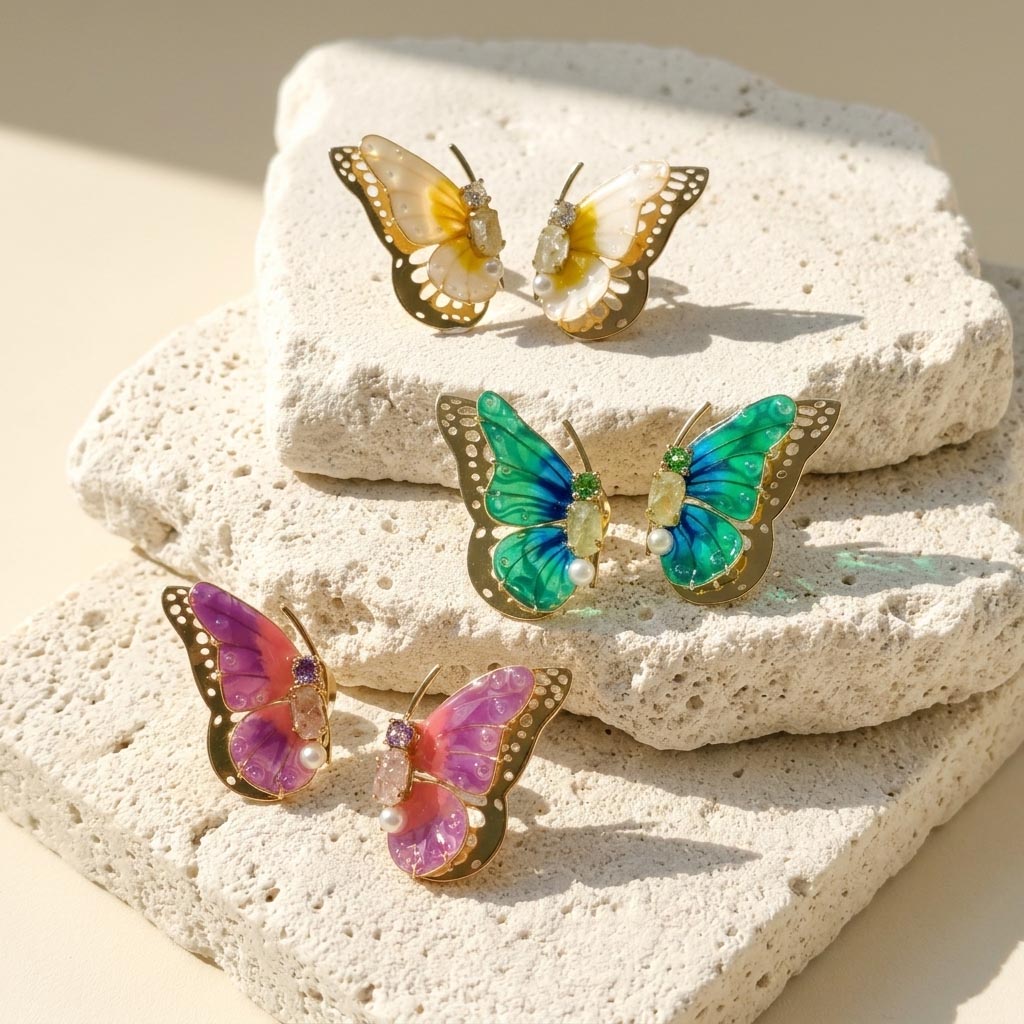 Butterfly-shaped earrings on a textured stone surface