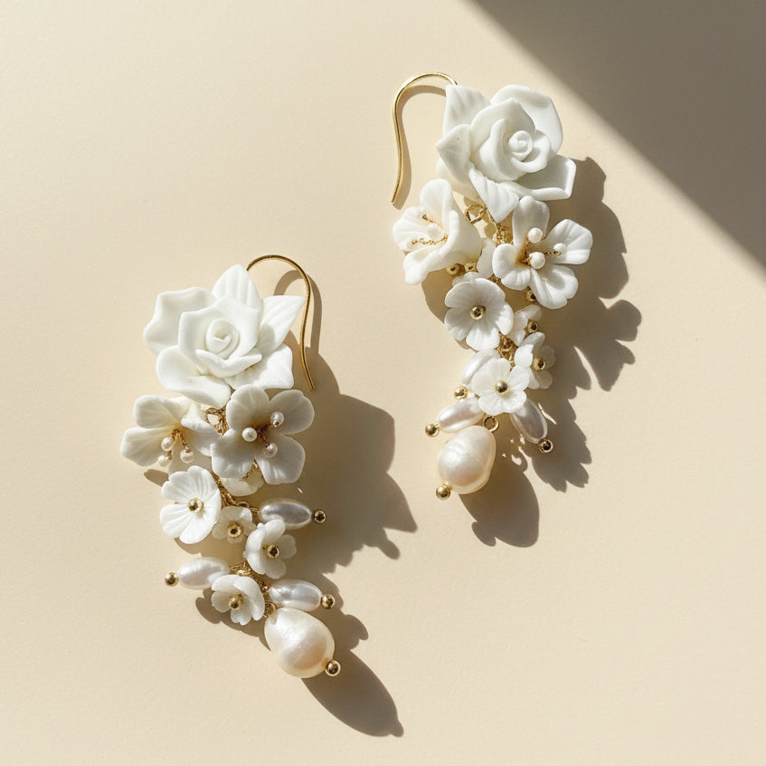 Close-up of handcrafted porcelain flower earrings with freshwater pearls.