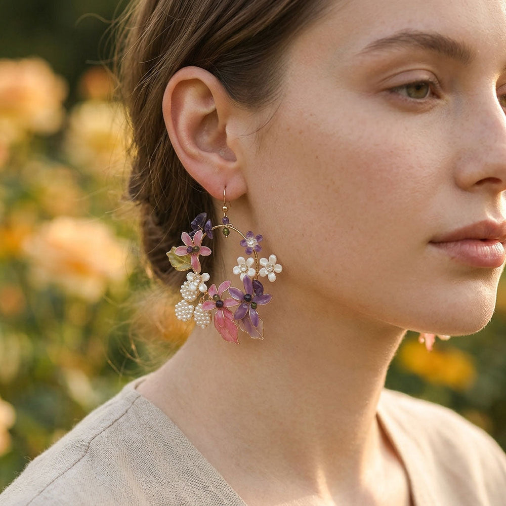 Close-up of a woman wearing floral earrings with a blurred natural background