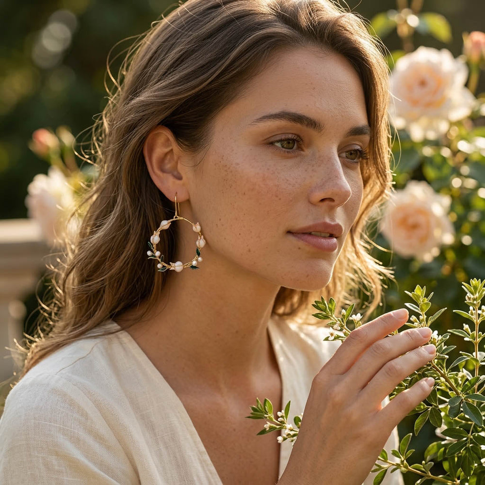 Woman wearing lily of the valley earrings with a garden background