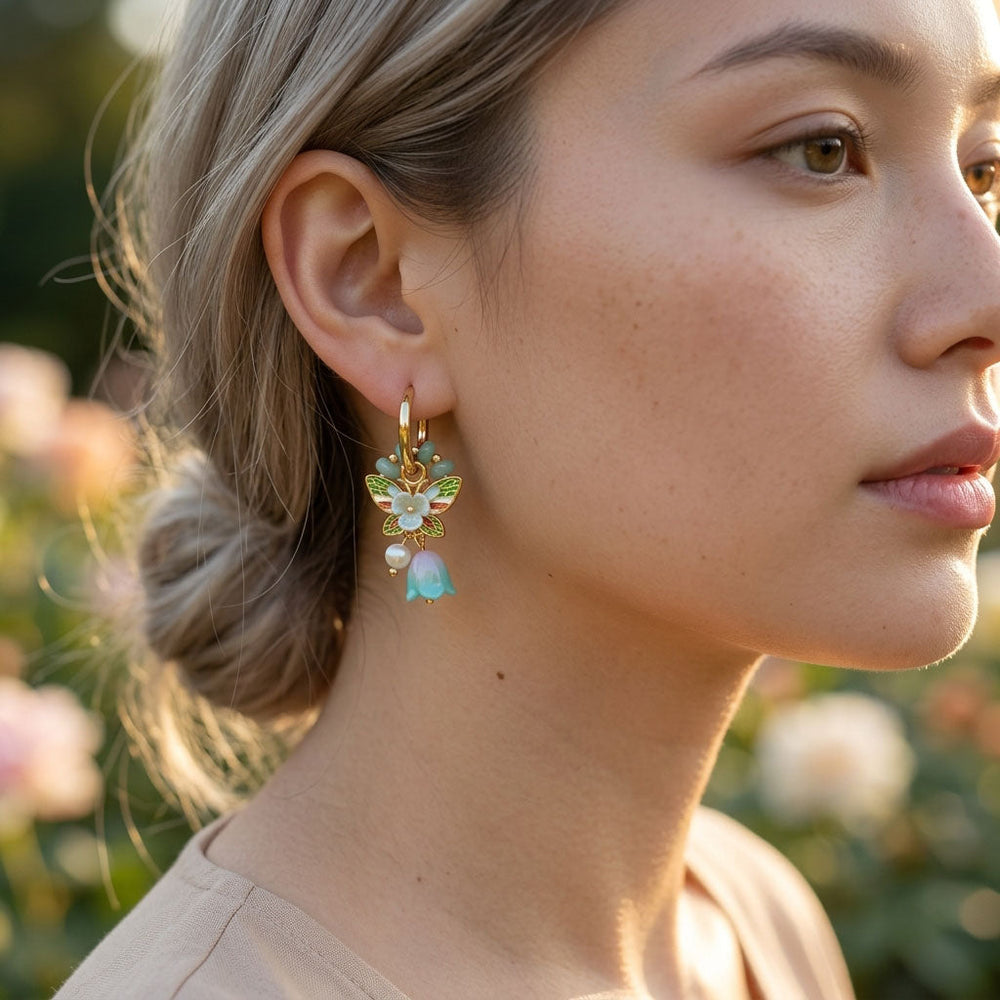 Close-up of a woman wearing a floral earring with a blurred natural background