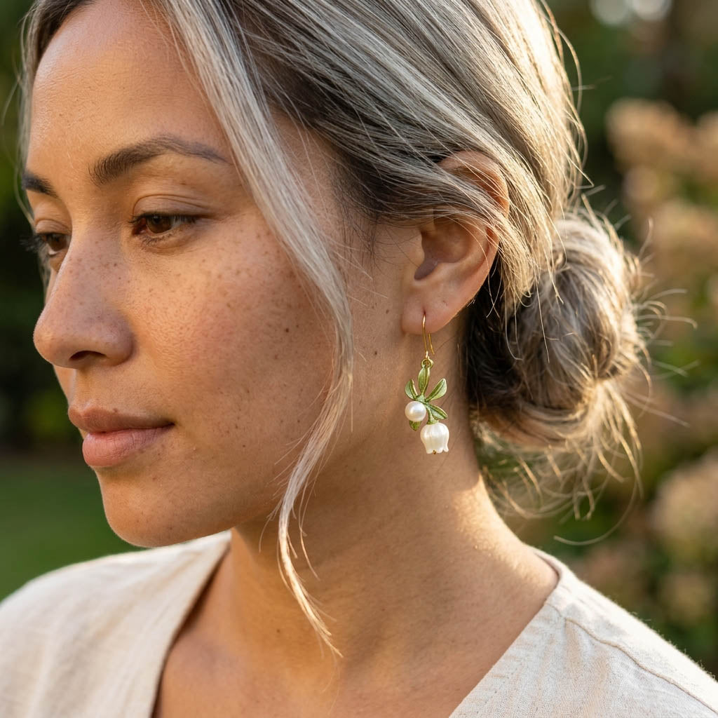 Woman wearing floral earrings with a blurred natural background