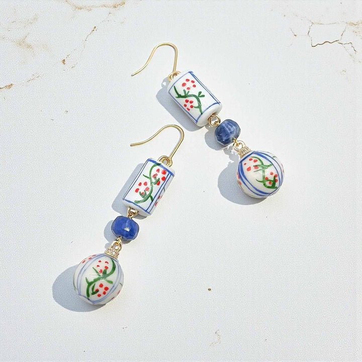 Pair of earrings with floral design beads on a light background