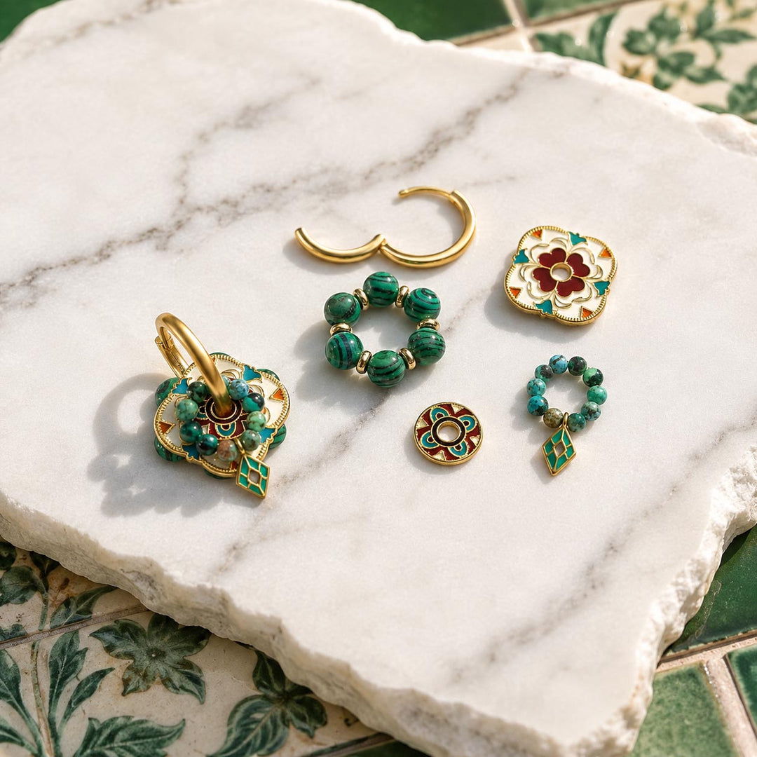 Convertible hoop earrings with malachite, African turquoise and hand-painted enamel shown with interchangeable components on a white marble slab with a green patterned tile surface underneath.