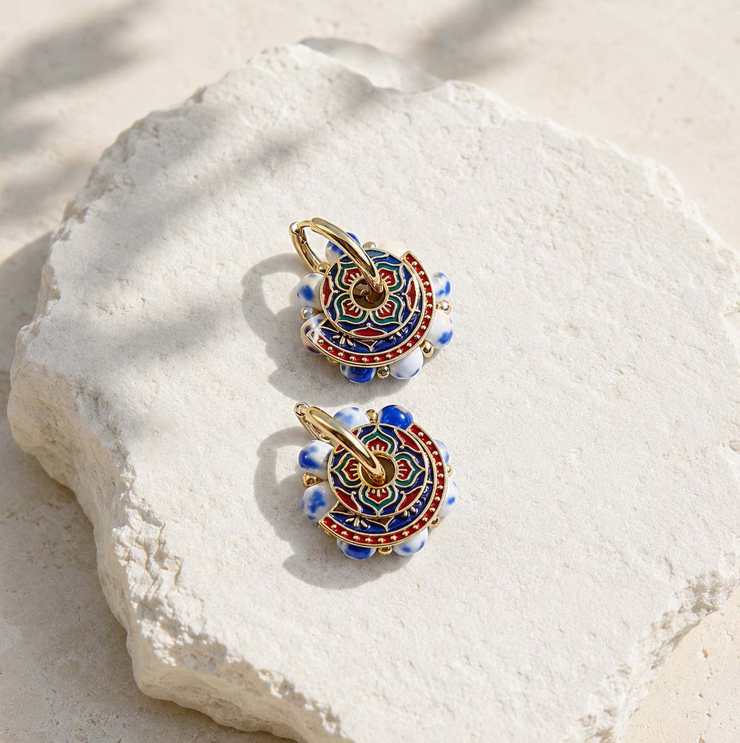 Blue porcelain convertible hoop earrings styled with detachable lapis stone drops and hand-painted enamel details.