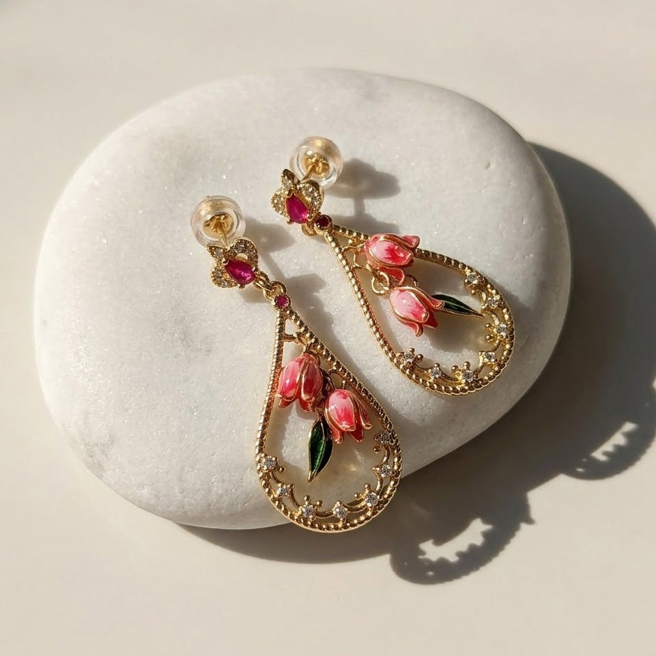 Pink Bellflower Enamel Drop Earrings on a white stone surface