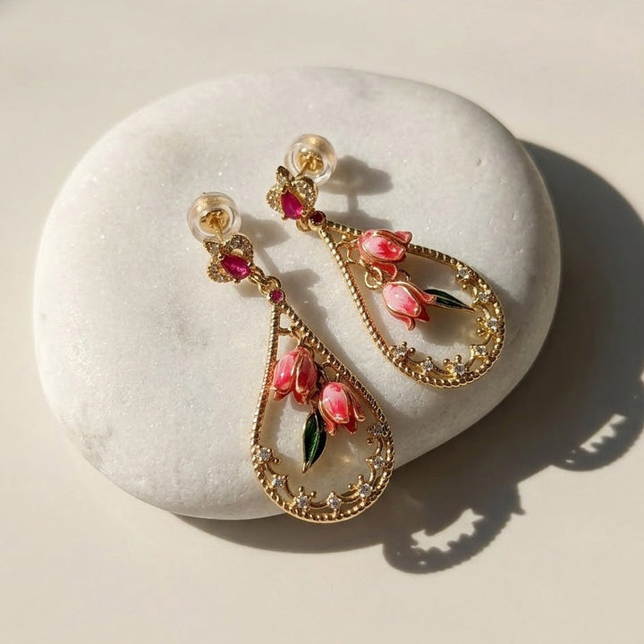 Pink Bellflower Enamel Drop Earrings on a white stone surface