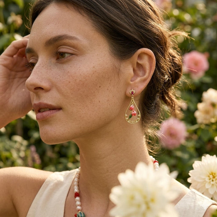 Woman wearing hand-painted Bellflower Earrings with CZ Accents in a garden setting