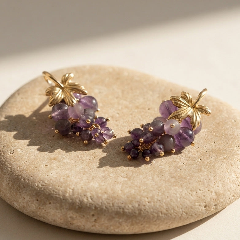 Handcrafted amethyst grape cluster earrings with 18K gold-plated brass on natural limestone.