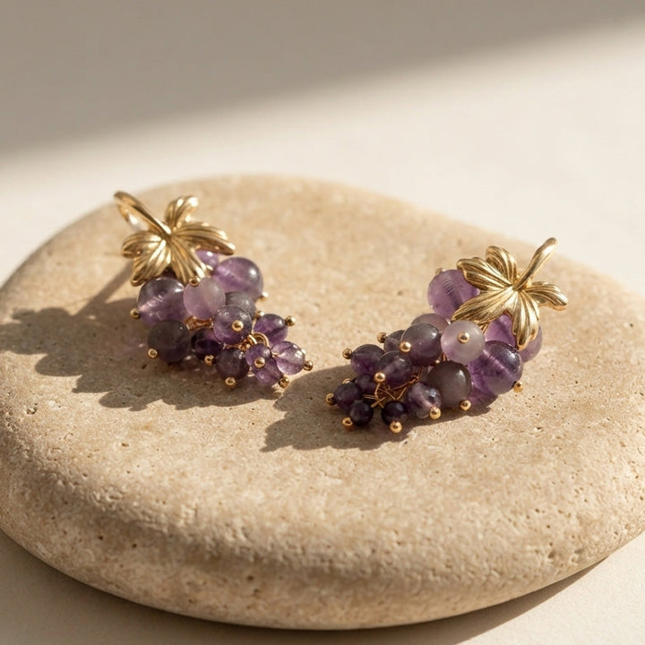 Handcrafted amethyst grape cluster earrings with 18K gold-plated brass on natural limestone.