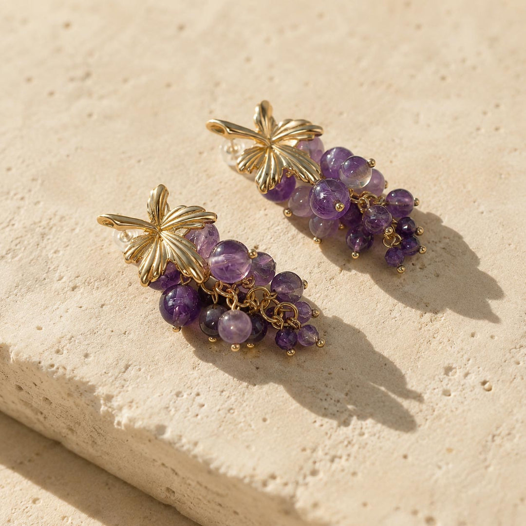 Close-up of A2K London amethyst grape cluster earrings featuring natural purple gemstones and botanical detailing.