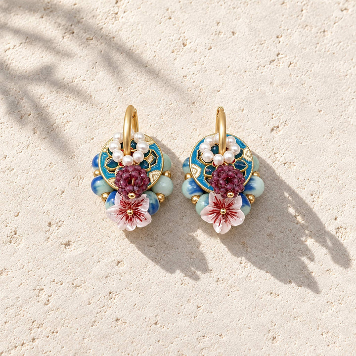 Convertible floral hoop earrings with freshwater pearls, garnet stones and hand-painted enamel on pale stone.