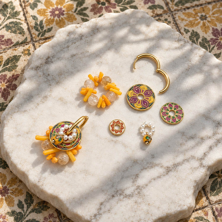 Citrine and coral convertible hoop earrings with hand-painted enamel on a sunlit stone surface.