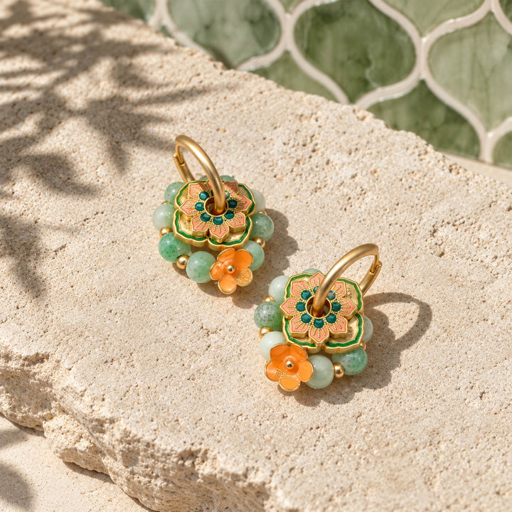 Green agate floral convertible earrings with hand-painted enamel details on sunlit textured stone.