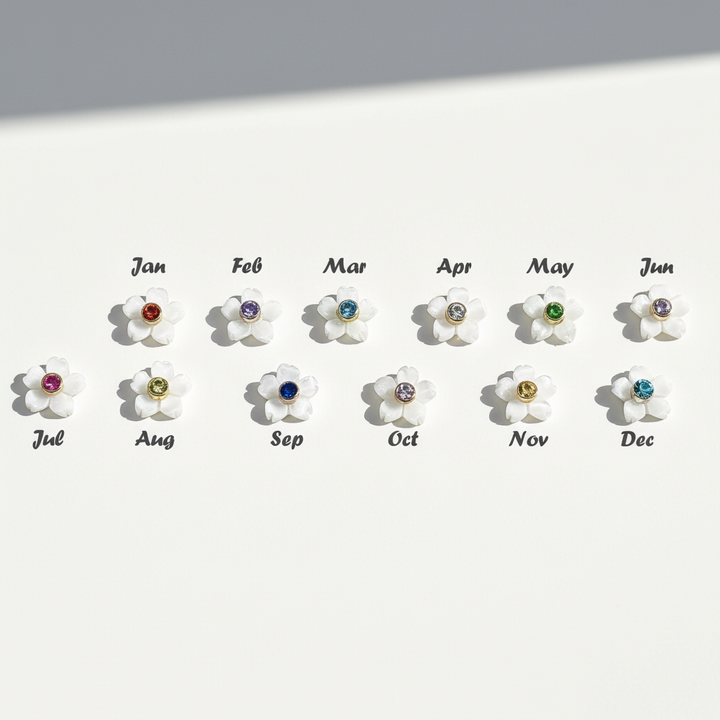 White flower charms with 12 colorful birthstone centers representing each month from January to December.
