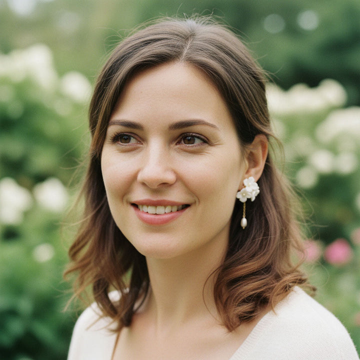 Model wearing A2K London porcelain and pearl earrings in garden, elegant floral style.