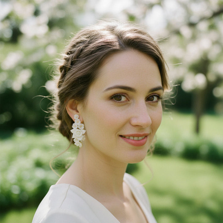 Woman with floral earrings in a garden setting