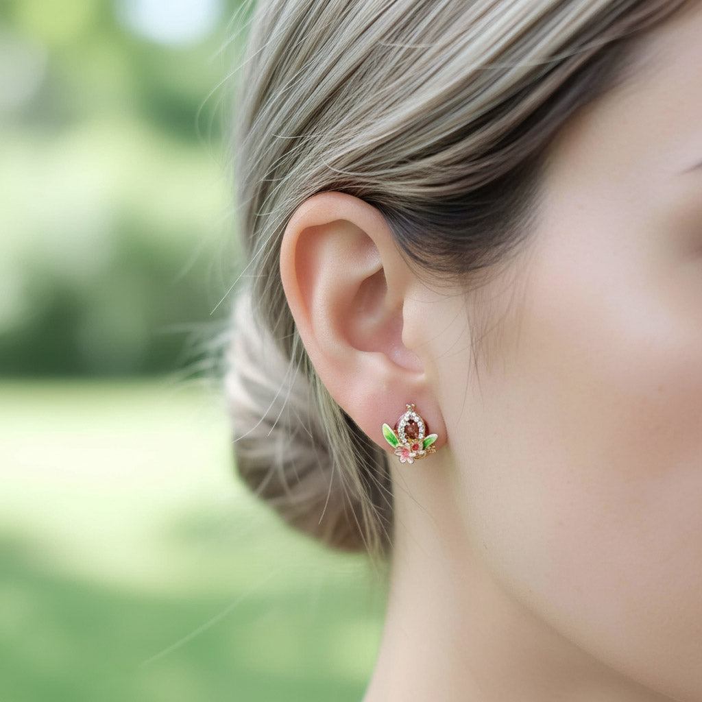 Model wearing small red enamel pomegranate stud earrings.