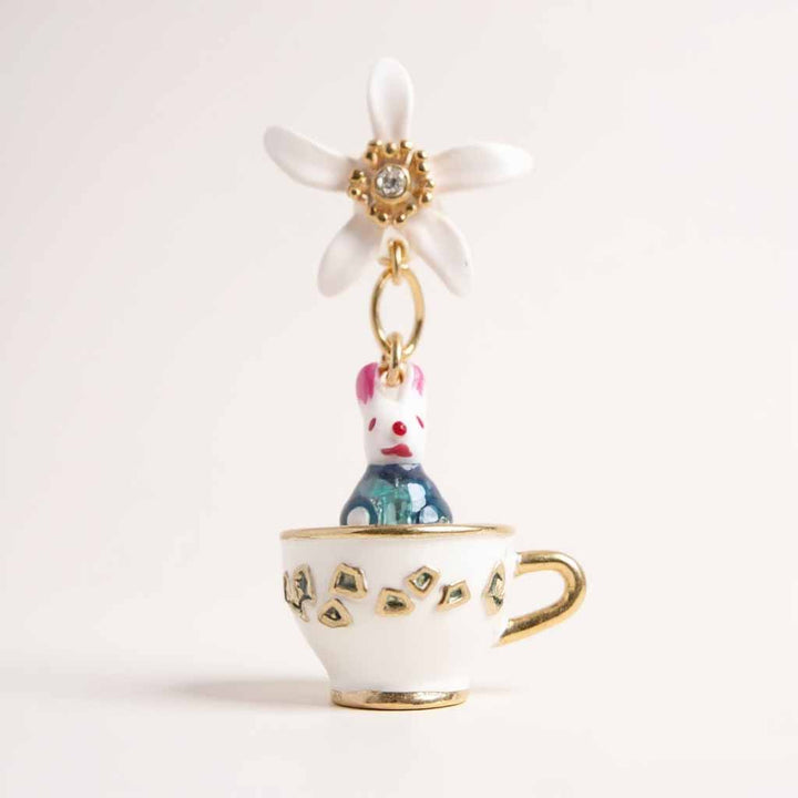 Teacup charm with a rabbit and flower on a white background