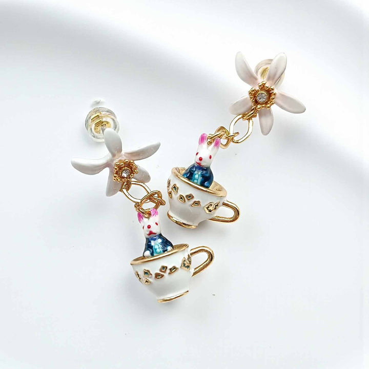 Earrings with teacup and rabbit design on a white background