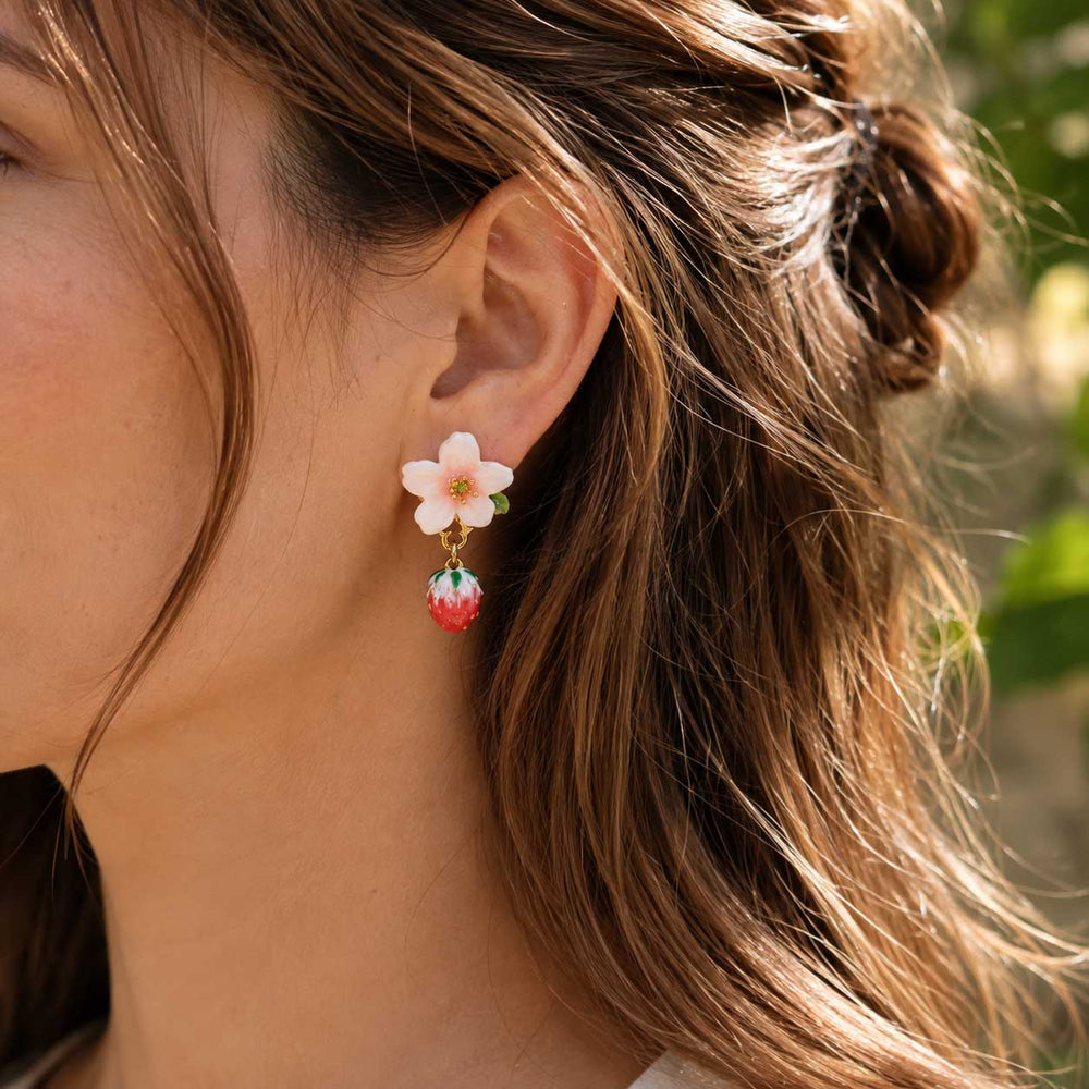 Close-up model photoshoot showcasing the pink cherry blossom strawberry earrings worn, highlighting the delicate botanical drop design and summer style.