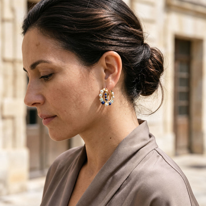 Model wearing layered gemstone hoop earrings with Lapis Lazuli, Amazonite and White Turquoise beads