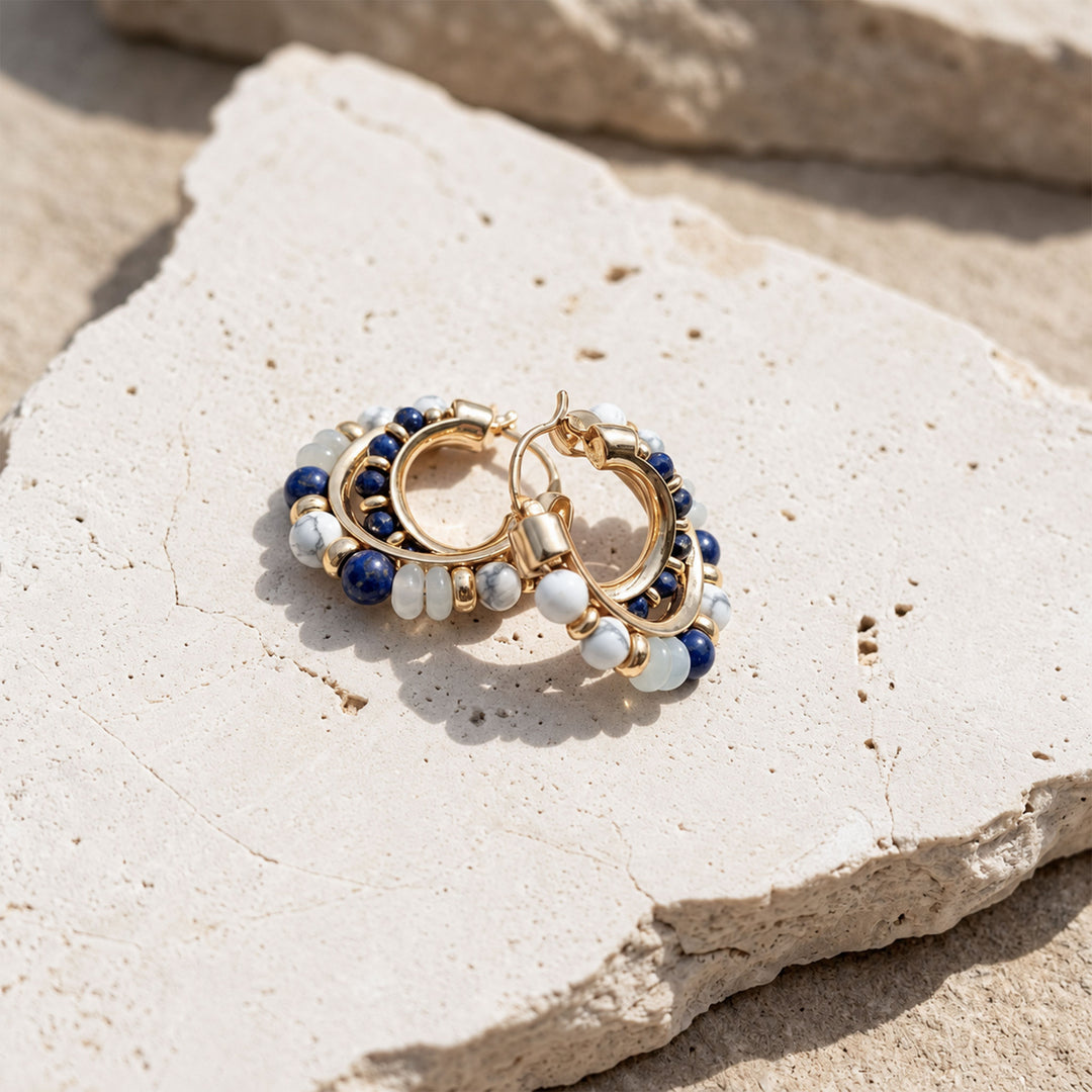 Layered Lapis Lazuli, Amazonite and White Turquoise hoop earrings displayed on limestone in sunlight
