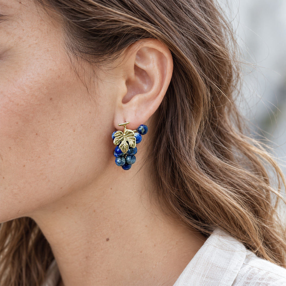 Model wearing Lapis Lazuli Grape Cluster Earrings with 18K gold-plated botanical leaf detail