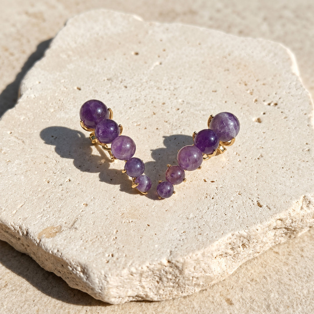 Amethyst Ear Climber Earrings with graduated 6 mm, 8 mm and 10 mm gemstone beads on limestone
