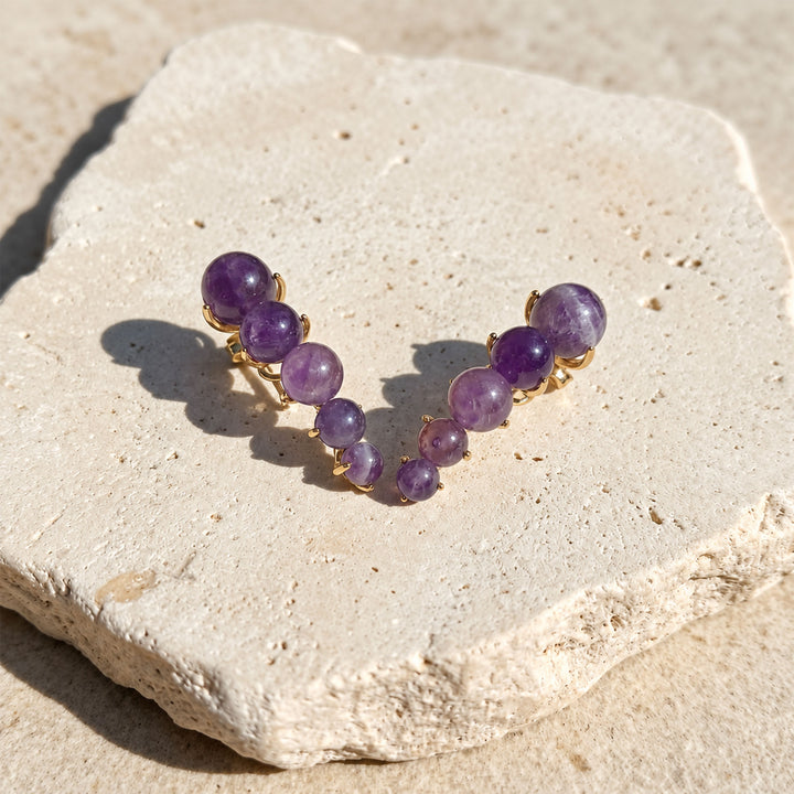 Amethyst Ear Climber Earrings with graduated 6 mm, 8 mm and 10 mm gemstone beads on limestone