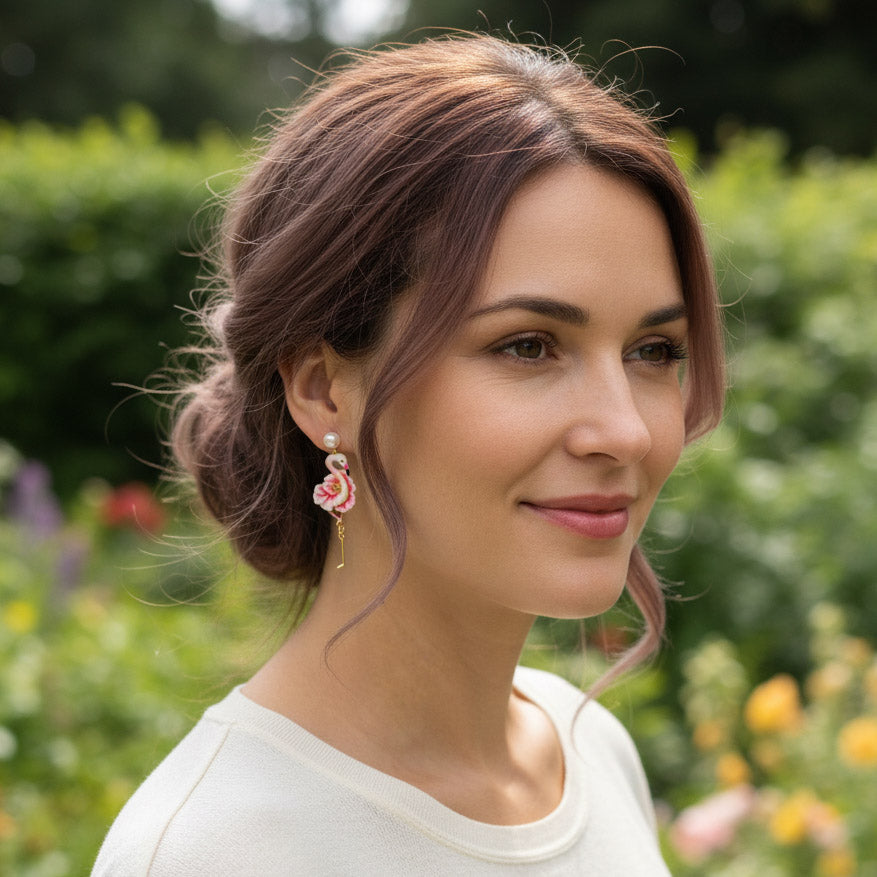 Woman with flamingo earrings in a garden setting