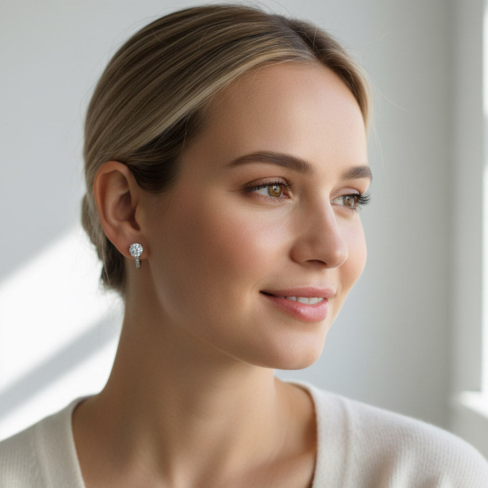 Elegant woman wearing round-cut lab-grown diamond earrings in silver setting