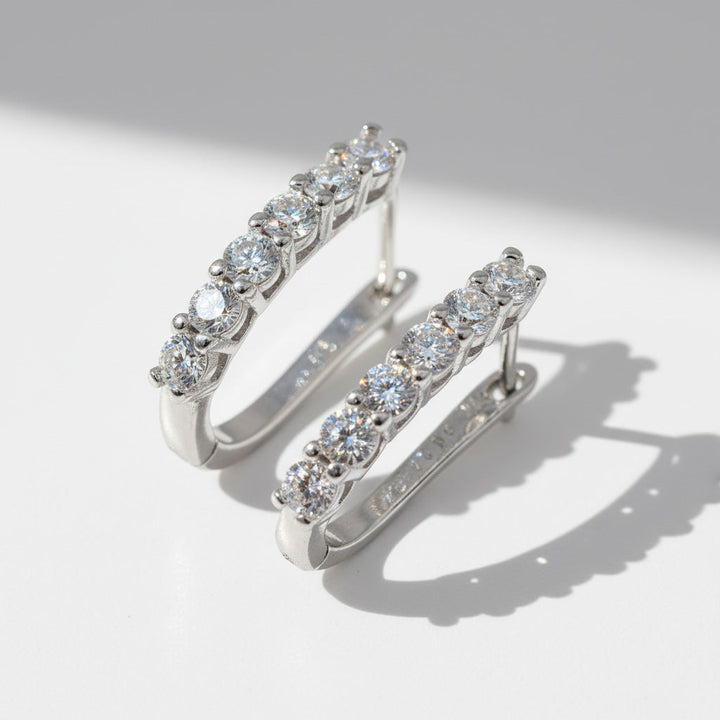 Close-up of sterling silver hoops featuring 1.2ct+1.2ct D/VVS1 lab-grown diamonds