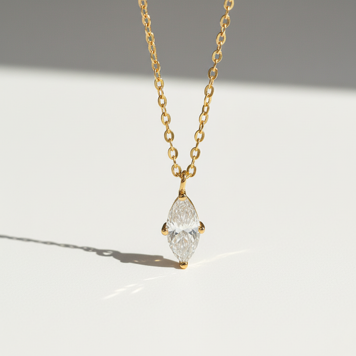 Gold-plated marquise 1ct D/VVS1 moissanite necklace on a clean sunlight background