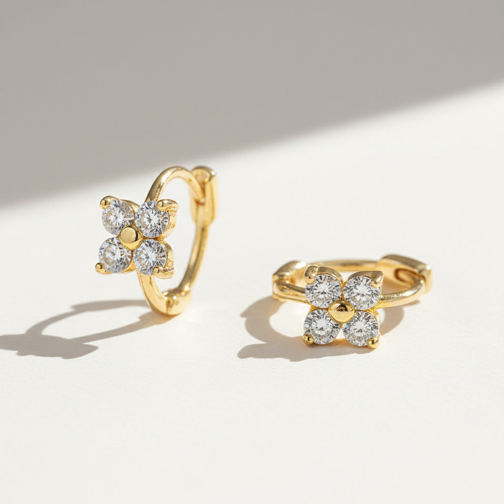 Gold-plated huggie hoops featuring four-petal moissanite flower design