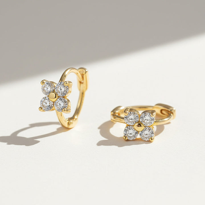 Gold-plated huggie hoops featuring four-petal moissanite flower design